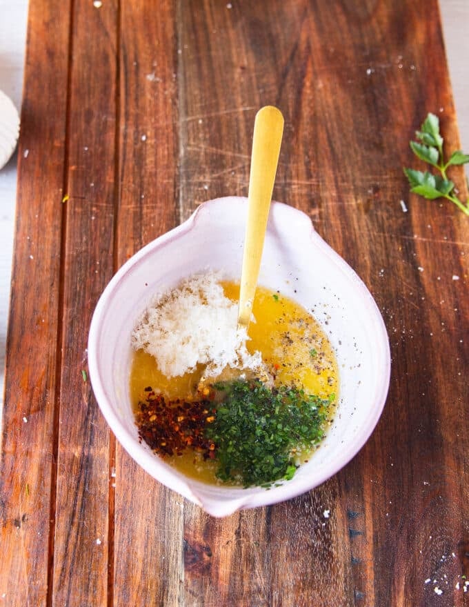 garlic butter herbs seasoning and lemon in a small bowl ready to mix for the garlic butter finish on the chicken spiedini