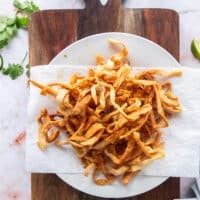 homemade tortilla strips on paper towels draining