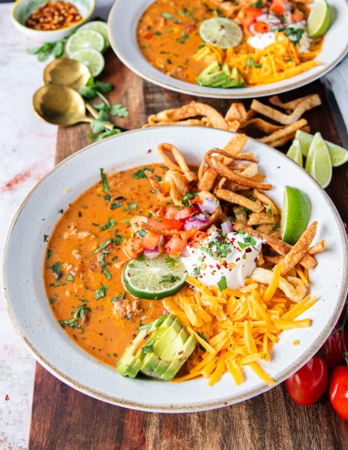 close up of a full bowl of chicken taco soup loaded with toppings and ready to eat