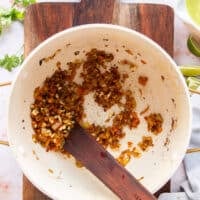 Onions, bell peppers and taco seasoning cooking to make the base of the chicken taco soup
