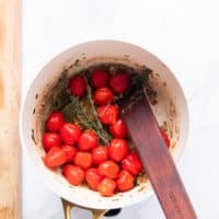 Tomatoes are added along with stock to deglaze the pan and make crab bisque