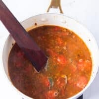 The tomatoes and stock base are added for the crab bisque base.