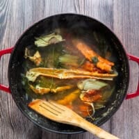Simmered and ready to strain crab stock in a large pot