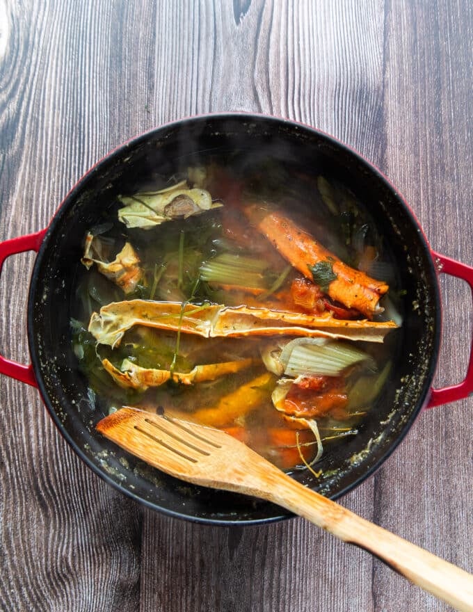 Simmered and ready to strain crab stock in a large pot
