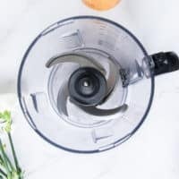 the bowl of a food processor ready for the dough