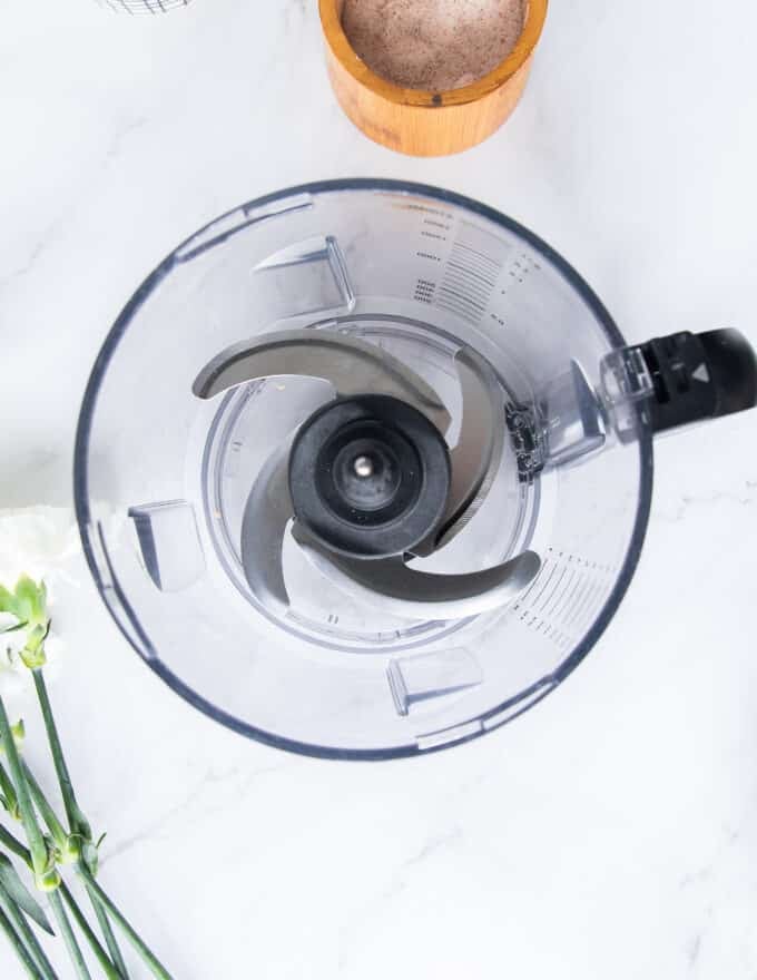 the bowl of a food processor ready for the dough