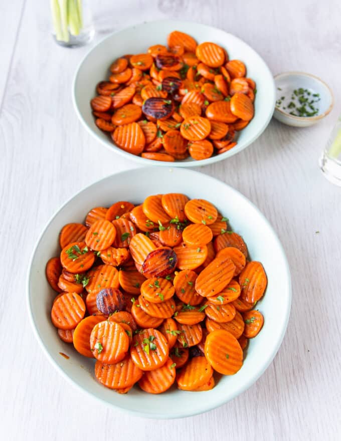 final serving platter of maple glazed carrots with golden perfectly cooked carrots finished with herbs 