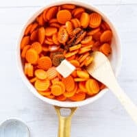 seasoning, maple syrup and butter are added to the partially cooked carrots