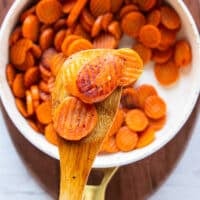 perfectly golden caramelized maple glazed carrots in the pan