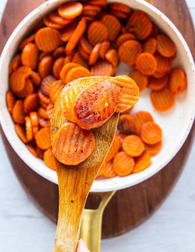perfectly golden caramelized maple glazed carrots in the pan