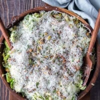 A final layer of freshly grated parmesan cheese is added over the salad