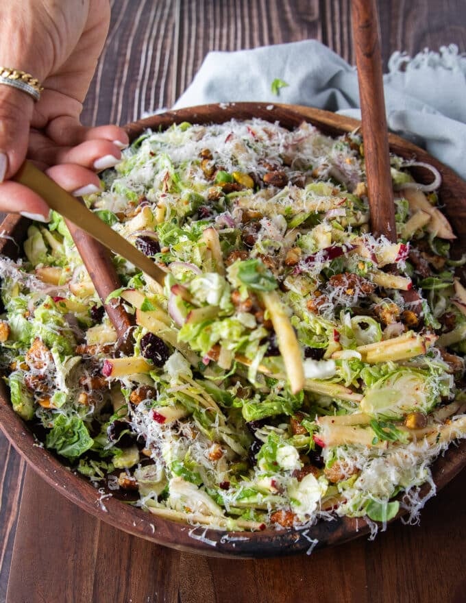 A full serving of brussel spout salad with candied walnuts, apples, cranberries and lots of parmesan cheese