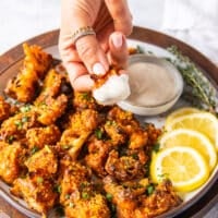 Buffalo cauliflower crispy and dipped and in ranch sauce