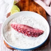 octopus added to a seasoned flour bowl