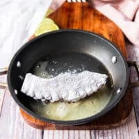 The flour coated octopus added to the frying pan