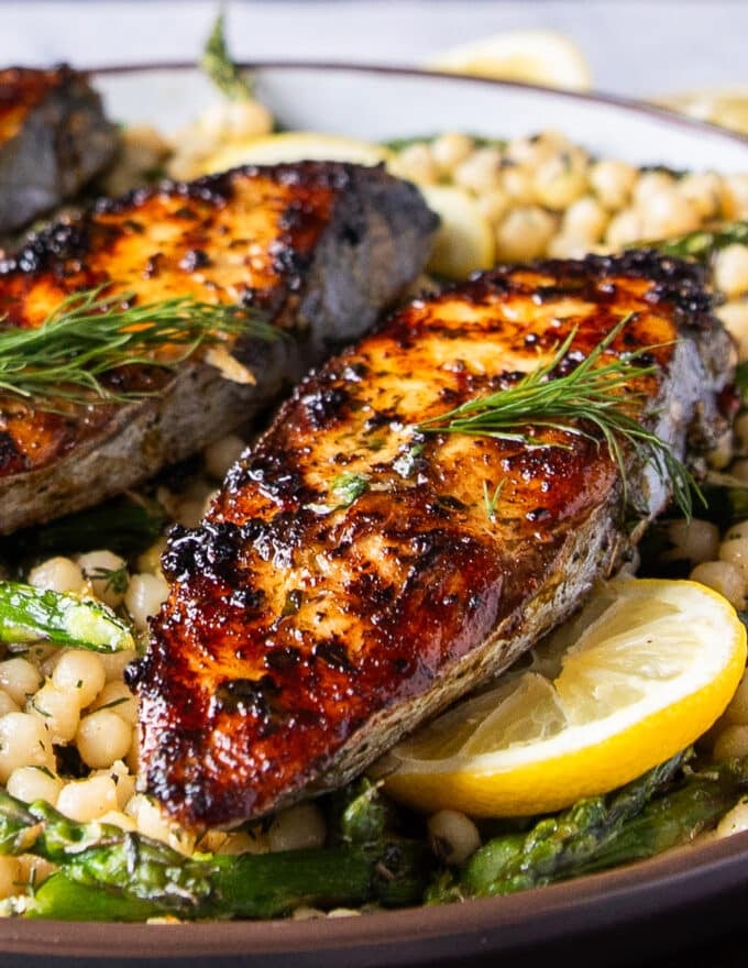 close up of king mackerel grilled to perfection showing the crisp skin and golden color 