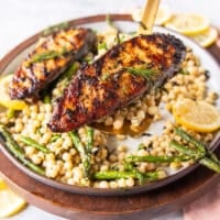 A spatula holding close up a cooked kingfish steak showing the golden grill mark on the fish