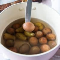 a knife poking through a potato showing how tender it is