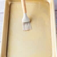 Oil and butter brushed over a baking sheet