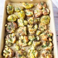 Read to roast tray of smashed potatoes with herbs and seasoning