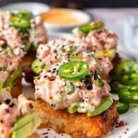 Spicy Tuna Crispy Rice topped with avocados and jalapenos, showing the crisp rice and creamy tuna