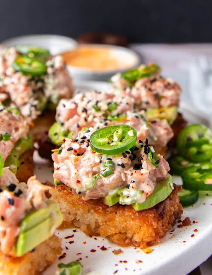 Spicy Tuna Crispy Rice topped with avocados and jalapenos, showing the crisp rice and creamy tuna