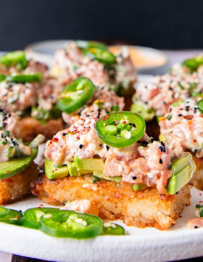 close up of one spicy tuna crispy rice showing the crisp golden brown and the creamy tuna topping