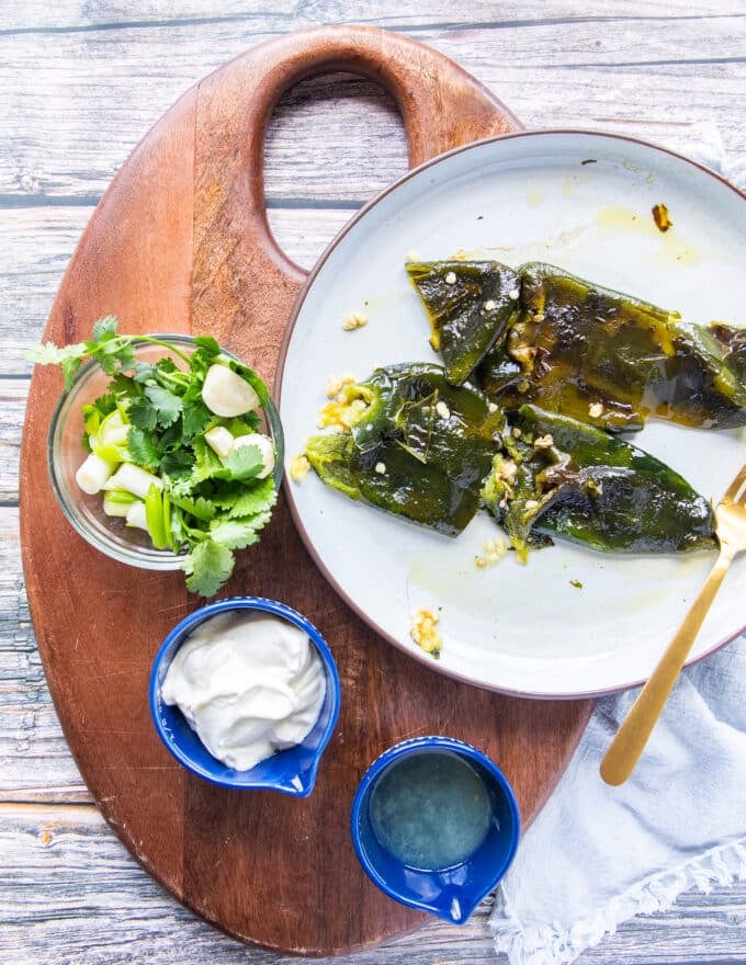 Ingredients for poblano sauce on a board in small boards