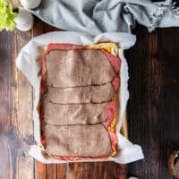 the roast beef slices layered on top of the cheese