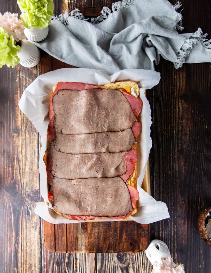 the roast beef slices layered on top of the cheese
