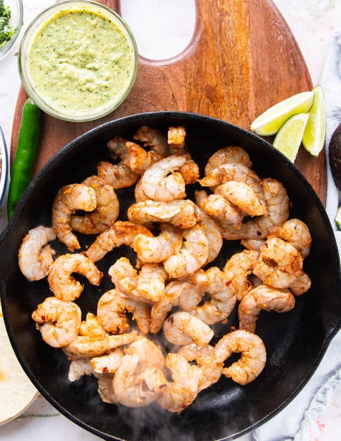seasoned shrimp added to a skillet to cook