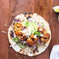 all toppings added to the shrimp tacos including avocados and cotija cheese and cilantro