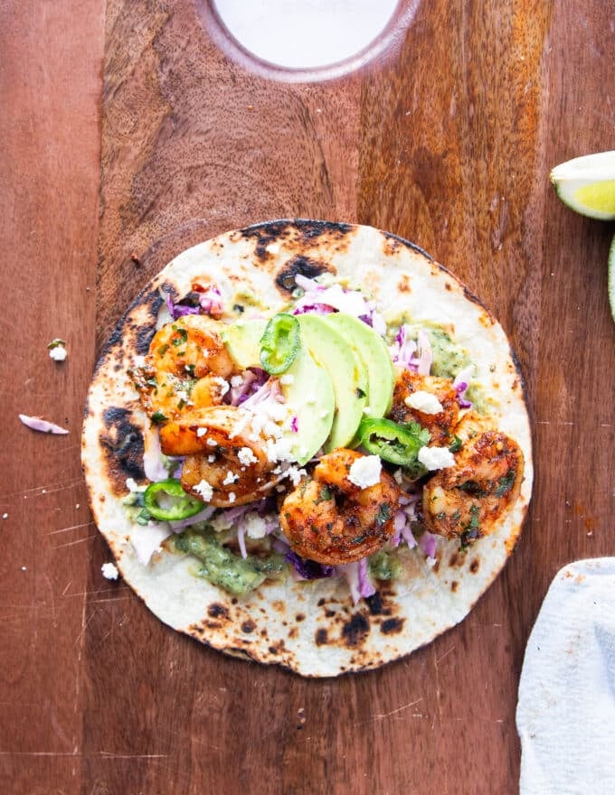 all toppings added to the shrimp tacos including avocados and cotija cheese and cilantro