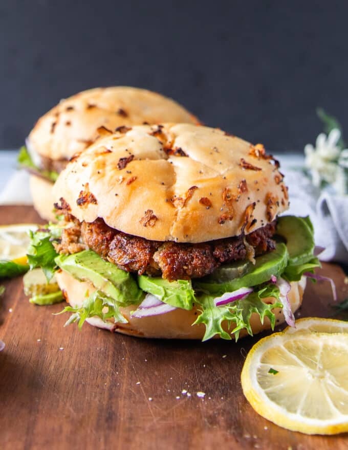 Close up pf a tuna burger showing the tuna burger patty recipe and bun along with the toppings