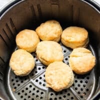 Biscuits golden and cooked in a single layer in the basket of the air fryer