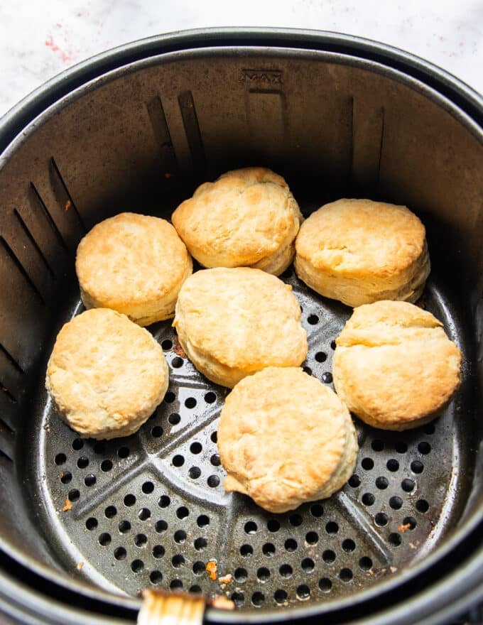 Biscuits golden and cooked in a single layer in the basket of the air fryer