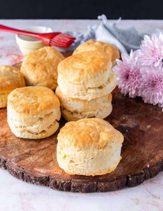 A table of air fryer biscuits ready and brushed with butter