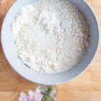 the buttermilk added to the bowl of flour and butter mixture