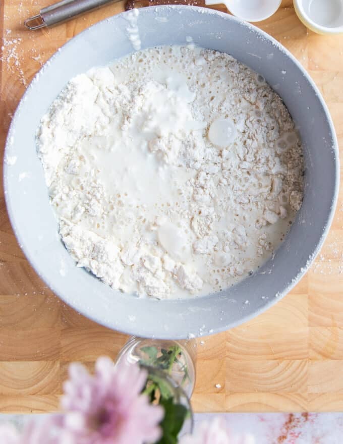 the buttermilk added to the bowl of flour and butter mixture