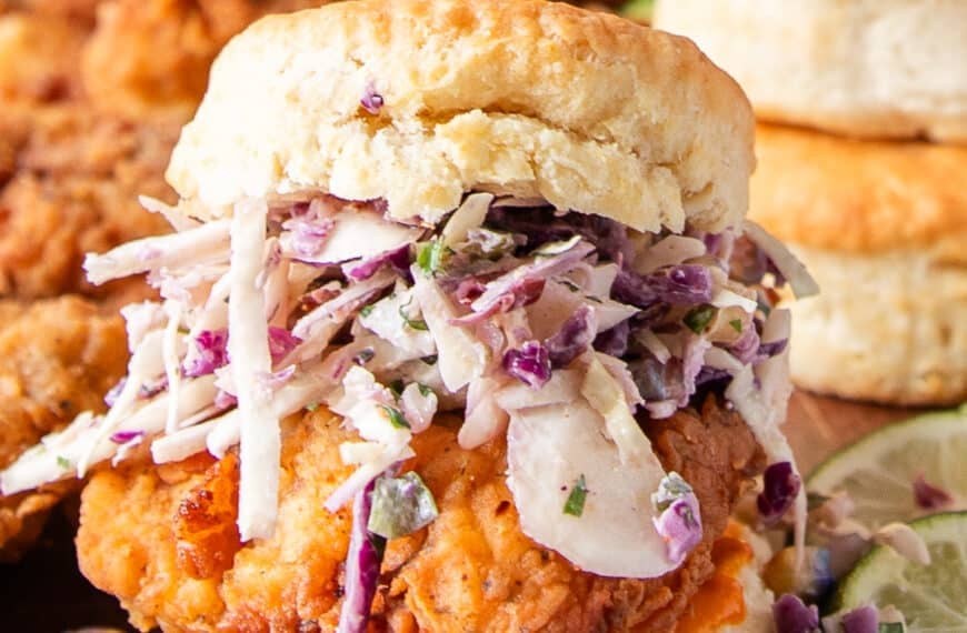 Chicken Biscuit layered with corn slaw and spicy chicken and biscuits