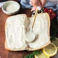 Spread tahini sauce over the crusty bread