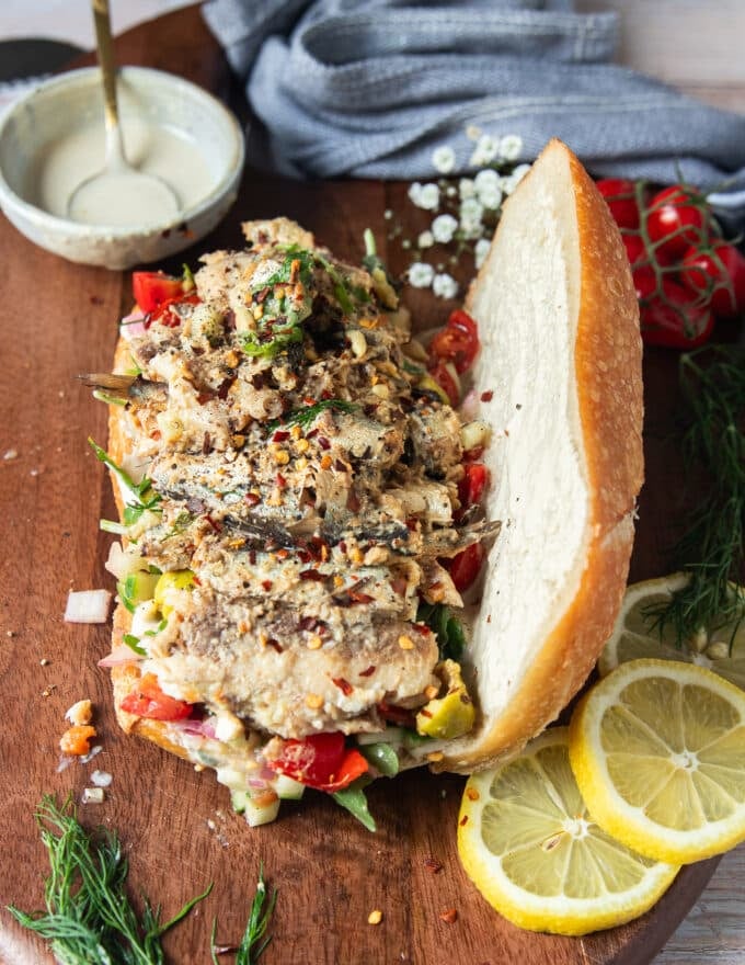 Sardines are added over the the veggies and salad ingredients