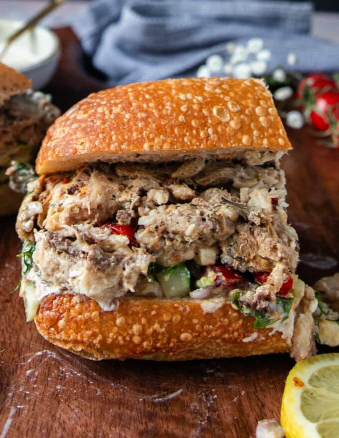 A cut up sardine sandwich close up