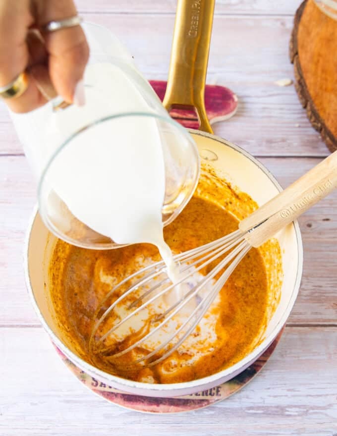 Add the dairy into the pan and cook while whisking 