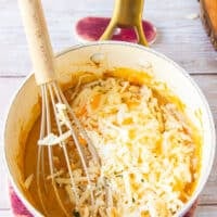 Shredded cheeses are added to the pan