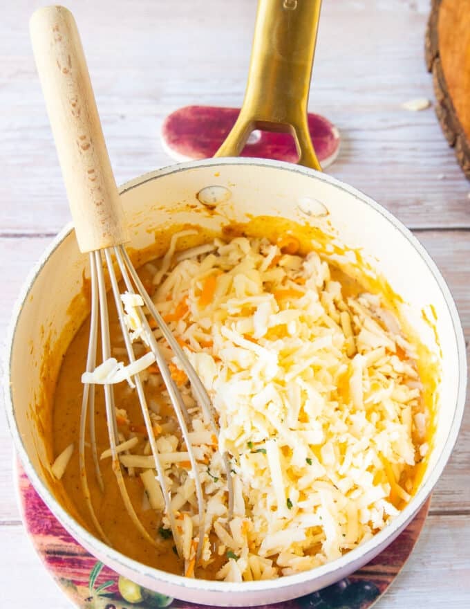 Shredded cheeses are added to the pan 
