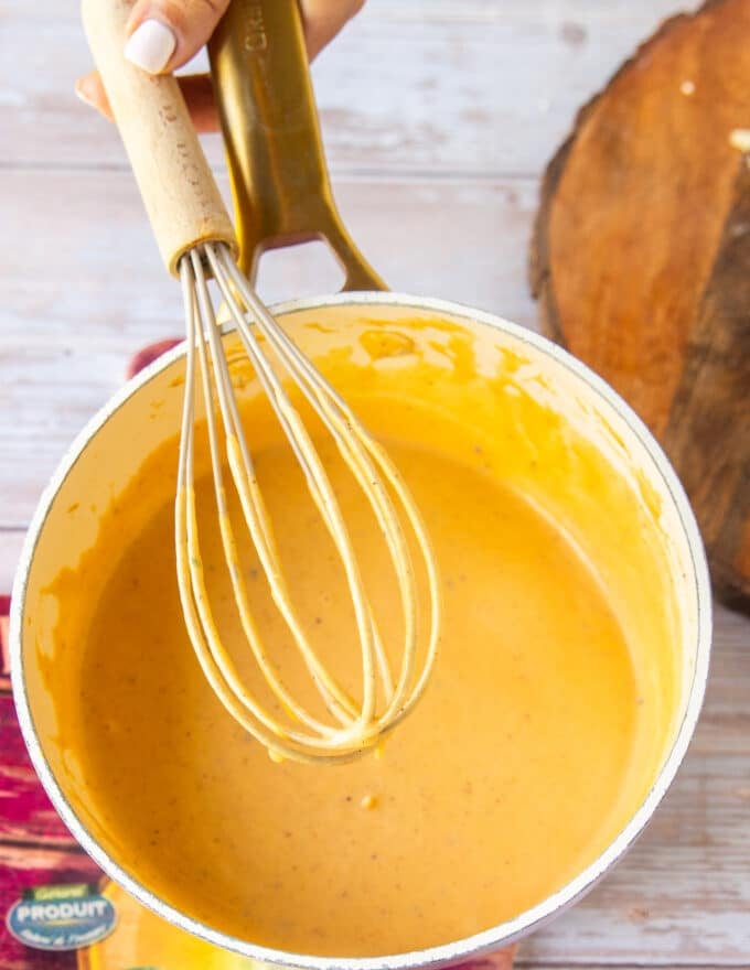 silky smooth cheese melted into the queso sauce now ready to flavor 