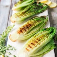 charred and grilled romaine lettuce flipped in the grill and ready to be dressed up