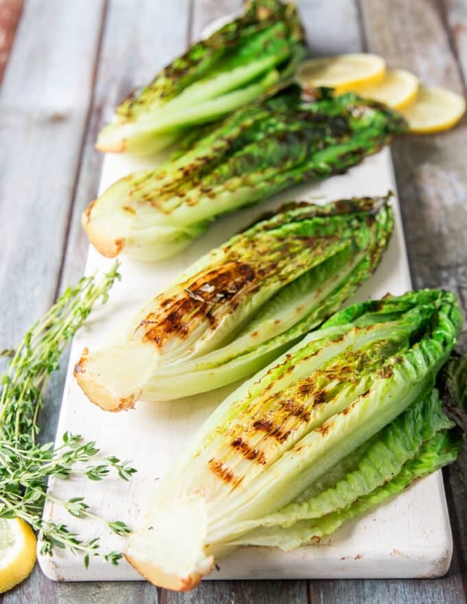charred and grilled romaine lettuce flipped in the grill and ready to be dressed up
