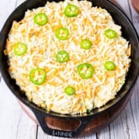 grated cheddar cheese and sliced jalapenos are added over the top of the batter before baking